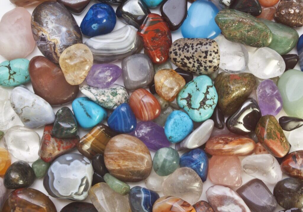 Colorful assorted polished gemstones on display.