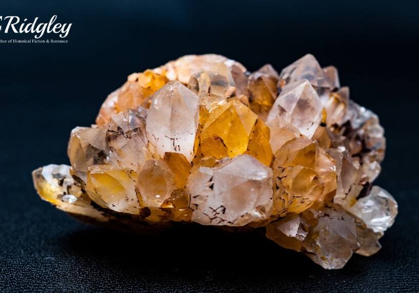 Cluster of orange and clear quartz crystals.