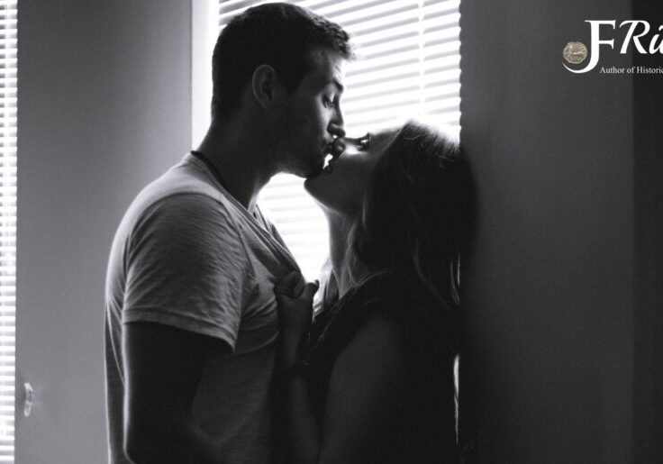 Couple kissing in black and white photo.