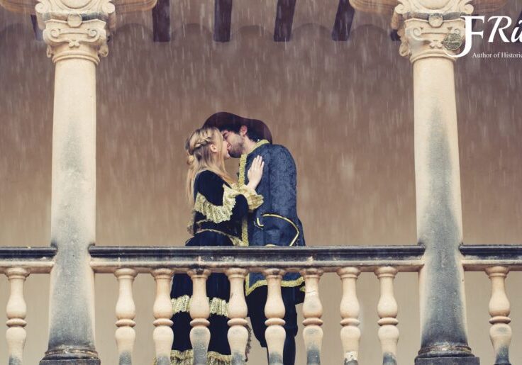 Couple kissing on a rainy balcony.